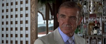 Movie still from “Never Say Never Again” (1983), directed by Irvin Kershner – An older man wearing a suit and tie; Close Up shot, Low angle