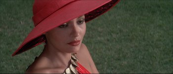 Movie still from “Never Say Never Again” (1983), directed by Irvin Kershner – A woman wearing a red hat and a red neck tie; Close Up shot, High angle