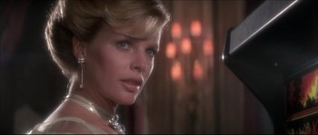 Movie still from “Never Say Never Again” (1983), directed by Irvin Kershner – A person wearing a necklace; Close Up shot, Over the shoulder angle