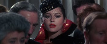 Movie still from “Never Say Never Again” (1983), directed by Irvin Kershner – A person wearing a hat; Close Up shot, Over the shoulder angle