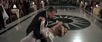 Movie still from “Never Say Never Again” (1983), directed by Irvin Kershner – A man and a woman are dancing in a ballroom; Medium shot, High angle