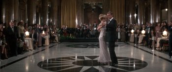 Movie still from “Never Say Never Again” (1983), directed by Irvin Kershner – A man and a woman in formal wear dancing in front of an audience; Wide shot, Low angle