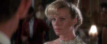 Movie still from “Never Say Never Again” (1983), directed by Irvin Kershner – A person wearing a necklace; Close Up shot, Over the shoulder angle