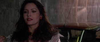 Movie still from “Never Say Never Again” (1983), directed by Irvin Kershner – A person with long dark hair; Close Up shot, Over the shoulder angle