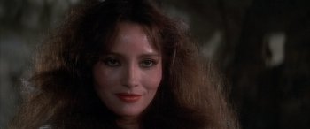 Movie still from “Never Say Never Again” (1983), directed by Irvin Kershner – A woman's face in a dark room; Close Up shot, Over the shoulder angle