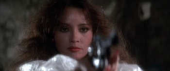 Movie still from “Never Say Never Again” (1983), directed by Irvin Kershner – A woman holding a pair of scissors; Close Up shot, Low angle