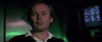 Movie still from “Never Say Never Again” (1983), directed by Irvin Kershner – A person wearing a suit and tie; Close Up shot, Low angle