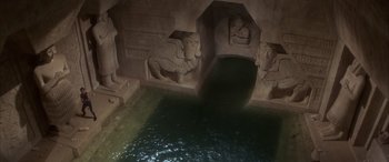 Movie still from “Never Say Never Again” (1983), directed by Irvin Kershner – An image of an egyptian temple with water in the foreground; Extreme Wide shot, High angle