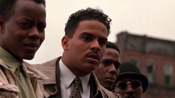 Movie still from “New Jack City” (1991), directed by Mario Van Peebles – A group of men standing next to each other; Close Up shot, Low angle