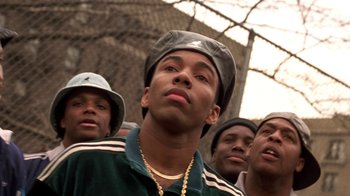 Movie still from “New Jack City” (1991), directed by Mario Van Peebles – A group of young men standing next to each other; Close Up shot, Low angle