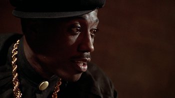 Movie still from “New Jack City” (1991), directed by Mario Van Peebles – A person wearing a hat; Close Up shot, Low angle