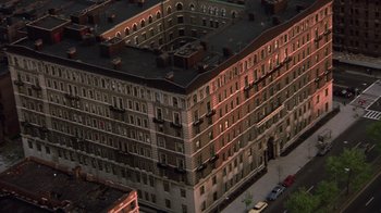 Movie still from “New Jack City” (1991), directed by Mario Van Peebles – An aerial view of an apartment building at night; Extreme Wide shot, High angle