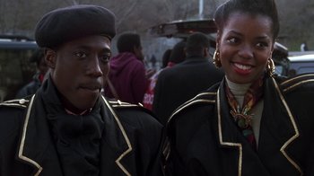 Movie still from “New Jack City” (1991), directed by Mario Van Peebles – A man and a woman standing next to each other; Close Up shot, Over the shoulder angle