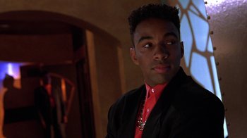 Movie still from “New Jack City” (1991), directed by Mario Van Peebles – A man in a red shirt and black jacket; Close Up shot, Low angle