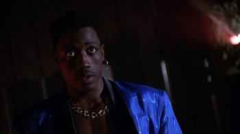 Movie still from “New Jack City” (1991), directed by Mario Van Peebles – A person wearing a jacket; Close Up shot, Low angle
