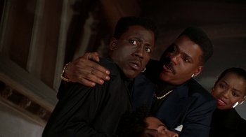 Movie still from “New Jack City” (1991), directed by Mario Van Peebles – A couple of men standing next to each other; Close Up shot, Low angle