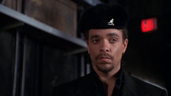 Movie still from “New Jack City” (1991), directed by Mario Van Peebles – A person wearing a hat; Close Up shot, Low angle