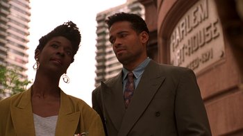 Movie still from “New Jack City” (1991), directed by Mario Van Peebles – A man and a woman standing next to each other; Close Up shot, Low angle