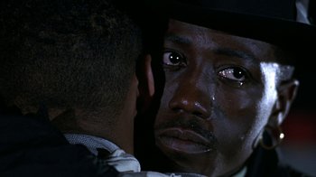 Movie still from “New Jack City” (1991), directed by Mario Van Peebles – A person crying in front of a mirror; Extreme Close Up shot, Over the shoulder angle