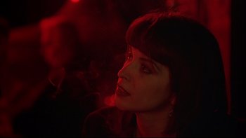 Movie still from “New Rose Hotel” (1998), directed by Abel Ferrara – A person in a dark room; Close Up shot, Low angle