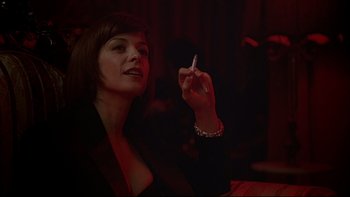 Movie still from “New Rose Hotel” (1998), directed by Abel Ferrara – A woman holding a cigarette in her hand; Close Up shot, Low angle