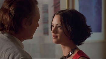 Movie still from “New Rose Hotel” (1998), directed by Abel Ferrara – A man and a woman looking at one another; Close Up shot, Over the shoulder angle