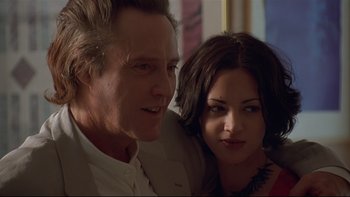 Movie still from “New Rose Hotel” (1998), directed by Abel Ferrara – A man and a woman posing for a picture; Close Up shot, Low angle