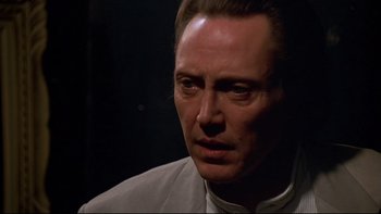 Movie still from “New Rose Hotel” (1998), directed by Abel Ferrara – A person wearing a white shirt; Close Up shot, Low angle