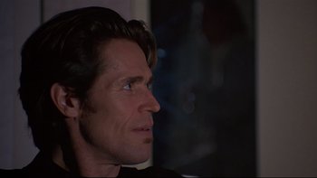 Movie still from “New Rose Hotel” (1998), directed by Abel Ferrara – A person looking up at something; Close Up shot, Over the shoulder angle