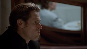 Movie still from “New Rose Hotel” (1998), directed by Abel Ferrara – Willem dafoe in a scene from the movie 't he last exorcism '; Close Up shot, Low angle