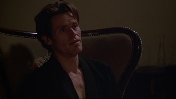 Movie still from “New Rose Hotel” (1998), directed by Abel Ferrara – A person sitting in a chair; Close Up shot, Over the shoulder angle