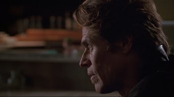 Movie still from “New Rose Hotel” (1998), directed by Abel Ferrara – A person looking to his left; Close Up shot, Over the shoulder angle