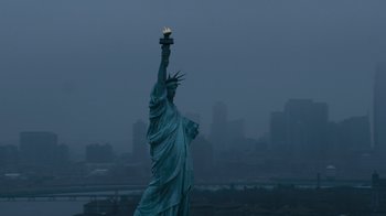 Movie still from “New Year's Eve” (2011), directed by Garry Marshall – The statue of liberty is lit up at night; Extreme Wide shot, Low angle