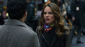 Movie still from “New Year's Eve” (2011), directed by Garry Marshall – A woman wearing a black jacket and a colorful scarf; Close Up shot, Over the shoulder angle