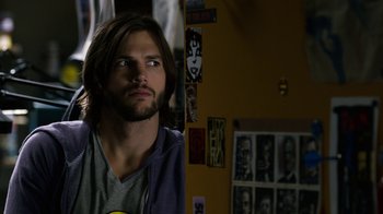 Movie still from “New Year's Eve” (2011), directed by Garry Marshall – A man with long brown hair looking to his left; Close Up shot, Over the shoulder angle
