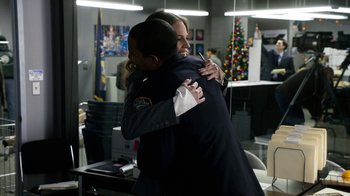 Movie still from “New Year's Eve” (2011), directed by Garry Marshall – A couple of people that are hugging in a room; Medium shot, Over the shoulder angle