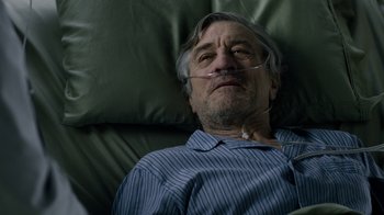 Movie still from “New Year's Eve” (2011), directed by Garry Marshall – An older man laying in a bed with a tube in his mouth; Close Up shot, High angle