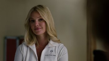 Movie still from “New Year's Eve” (2011), directed by Garry Marshall – A woman with blonde hair wearing a white shirt; Close Up shot, Over the shoulder angle