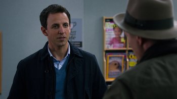 Movie still from “New Year's Eve” (2011), directed by Garry Marshall – A man standing next to another man wearing a hat; Close Up shot, Over the shoulder angle