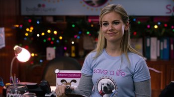 Movie still from “New Year's Eve” (2011), directed by Garry Marshall – A woman wearing a t - shirt that says " save a life "; Close Up shot, Over the shoulder angle