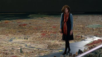 Movie still from “New Year's Eve” (2011), directed by Garry Marshall – A woman standing in front of a map of a city; Wide shot, Over the shoulder angle