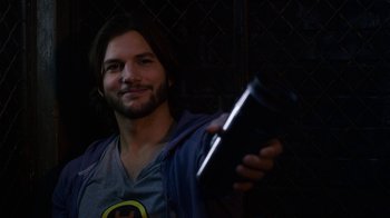 Movie still from “New Year's Eve” (2011), directed by Garry Marshall – A man holding a cell phone in his hand; Close Up shot, Over the shoulder angle