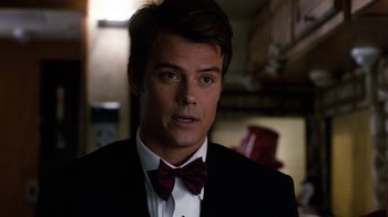 Movie still from “New Year's Eve” (2011), directed by Garry Marshall – A person wearing a suit and a bow tie; Close Up shot, Over the shoulder angle