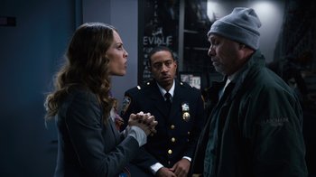 Movie still from “New Year's Eve” (2011), directed by Garry Marshall – A group of people standing next to each other in a room; Medium shot, Over the shoulder angle