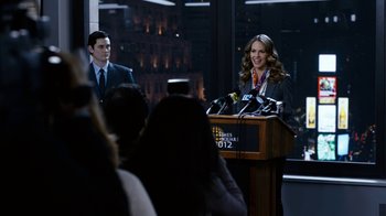 Movie still from “New Year's Eve” (2011), directed by Garry Marshall – A man and a woman standing in front of microphones; Medium shot, Over the shoulder angle