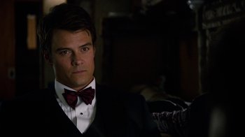 Movie still from “New Year's Eve” (2011), directed by Garry Marshall – A man wearing a suit and bow tie; Close Up shot, Over the shoulder angle