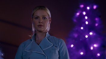 Movie still from “New Year's Eve” (2011), directed by Garry Marshall – A beautiful blonde woman in front of a christmas tree; Close Up shot, Low angle