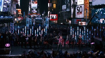 Movie still from “New Year's Eve” (2011), directed by Garry Marshall – A group of people walking on a city street at night; Extreme Wide shot, High angle