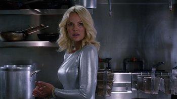 Movie still from “New Year's Eve” (2011), directed by Garry Marshall – A woman standing in a kitchen wearing a silver top; Close Up shot, Low angle