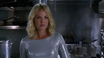 Movie still from “New Year's Eve” (2011), directed by Garry Marshall – A woman with blonde hair wearing a silver top; Close Up shot, Over the shoulder angle